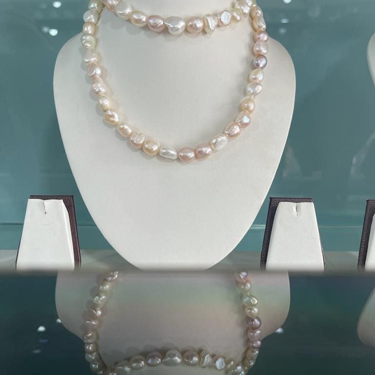 Luxurious long strand of natural pearls, ideal for layering or wearing solo for a classic and timeless look.