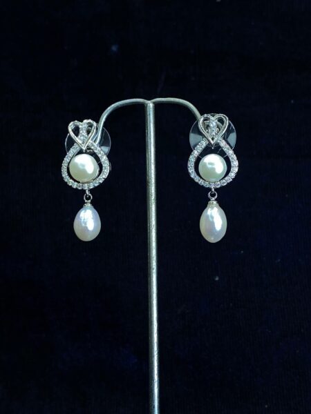 Heart and Soul Pearl Studs featuring a romantic heart-shaped design with pearls.