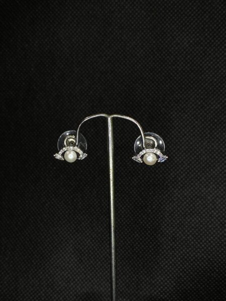 Pearl Wing Studs featuring a delicate wing design with a central pearl.