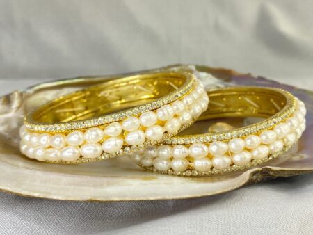 Double Line Pearl Bangle featuring two rows of lustrous pearls set in an elegant and sophisticated design.