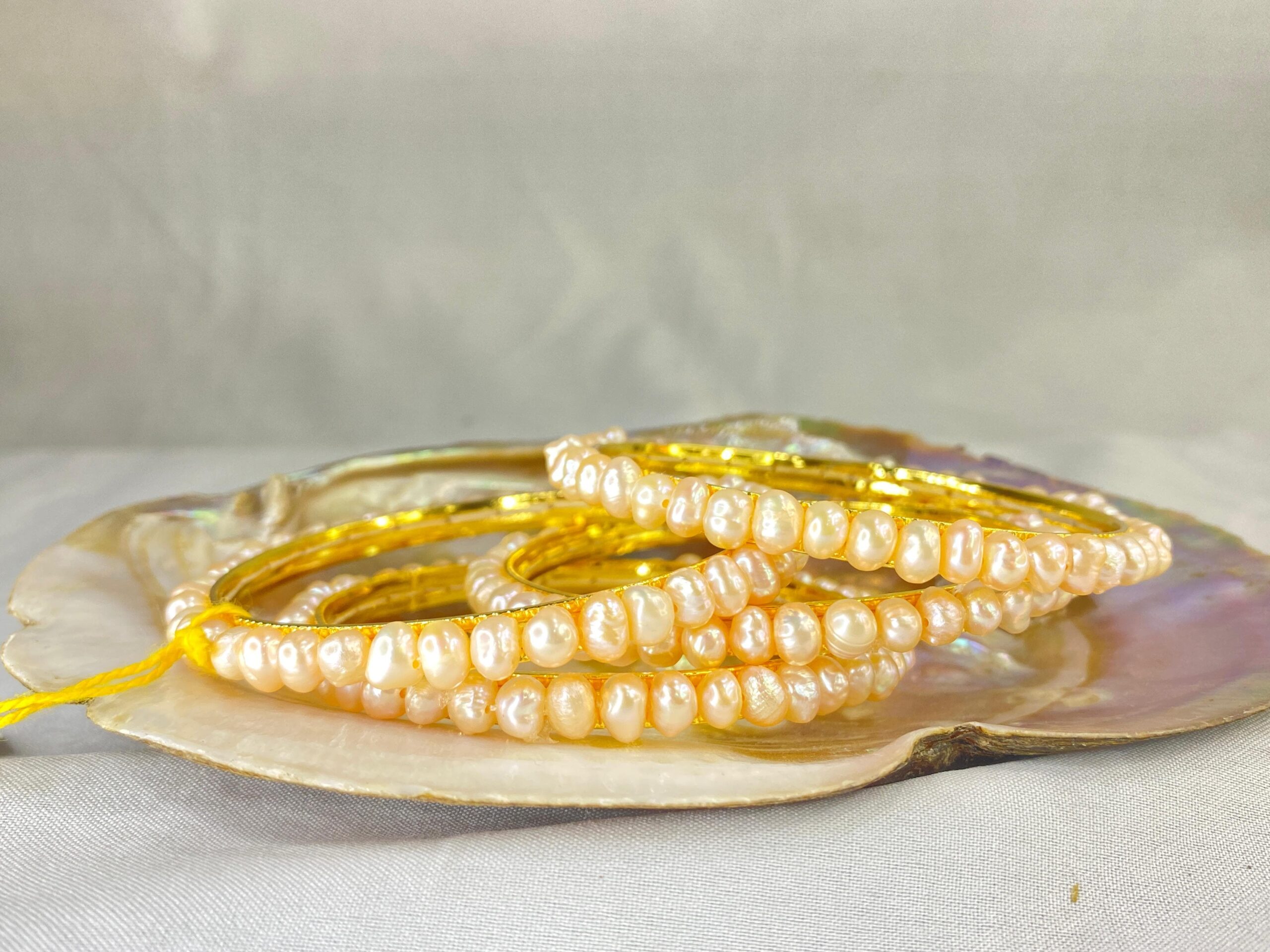 Pink Pearl Bangle featuring soft pink pearls set in an elegant and timeless design.