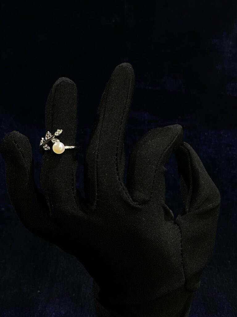 Delicate Leaf Pearl Ring with intricate leaf patterns and a luminous pearl centerpiece.