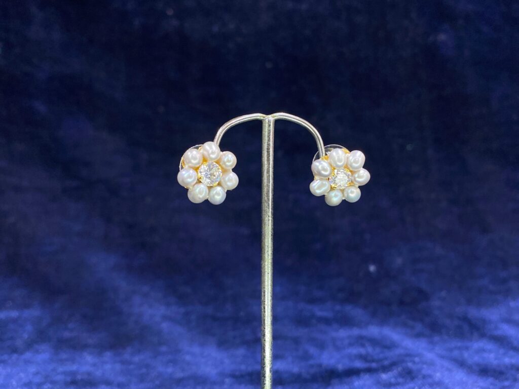 Pearl Daisy Stud Tops with a charming daisy-inspired floral design and pearl center.