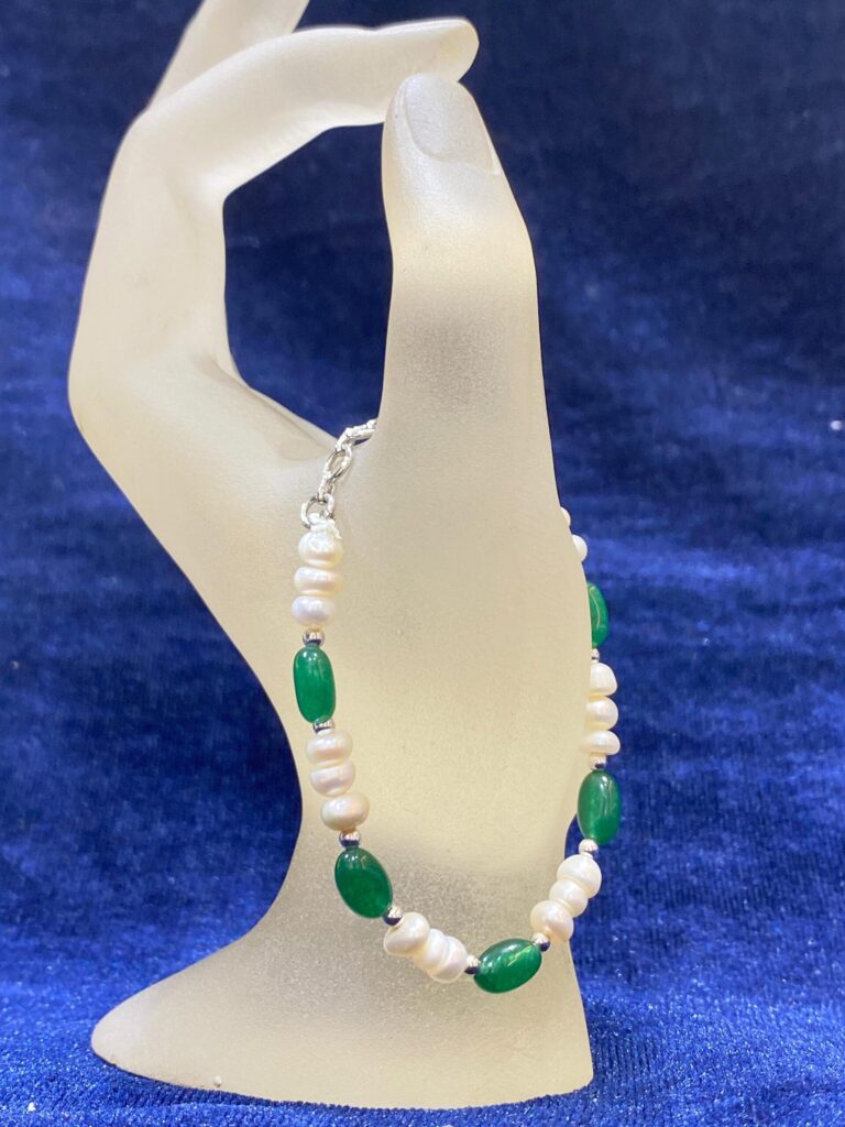 Emerald and Pearl Bracelet showcasing vibrant green emeralds and luminous pearls.