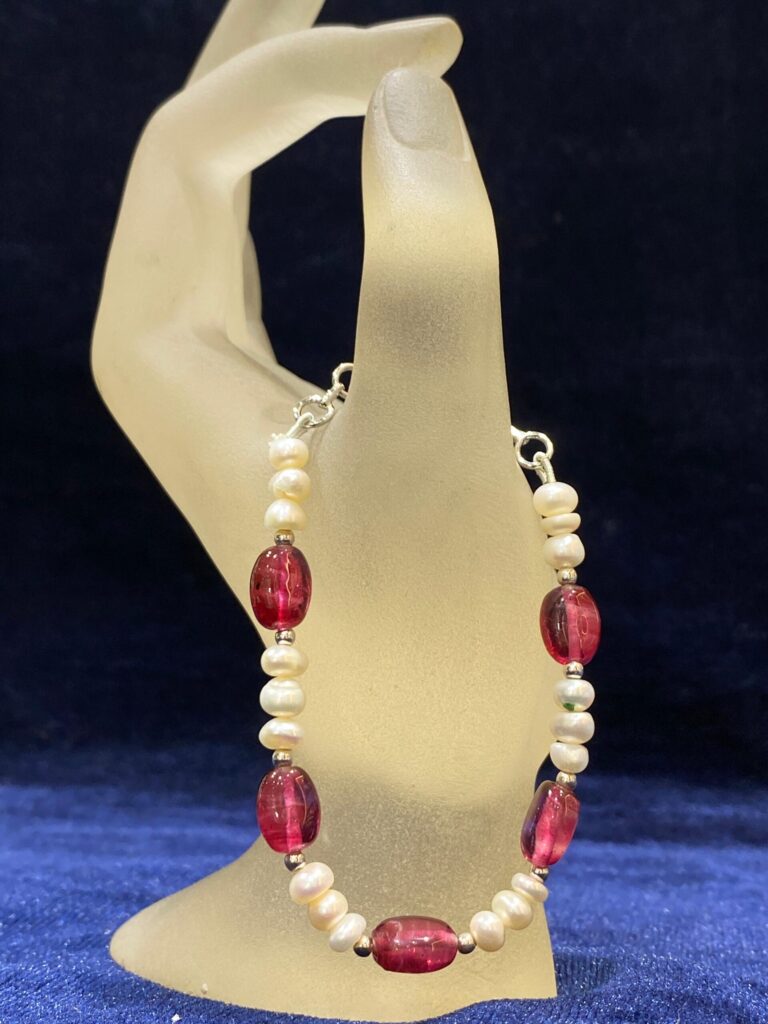Pearl and Sapphire Bracelet featuring radiant pearls and deep blue sapphires.