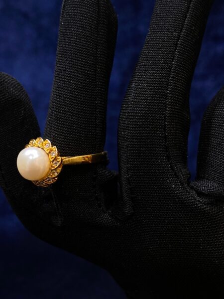 Pearl Blossom Ring featuring a delicate floral design with a luminous pearl center.