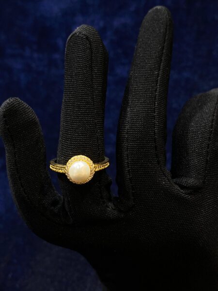 Pearl Halo Ring with a radiant pearl surrounded by a shimmering halo design.
