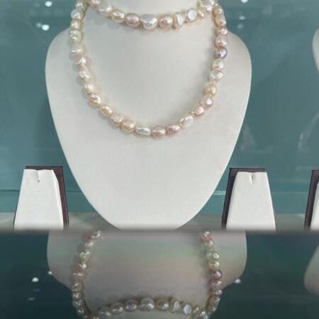 Luxurious long strand of natural pearls, ideal for layering or wearing solo for a classic and timeless look.