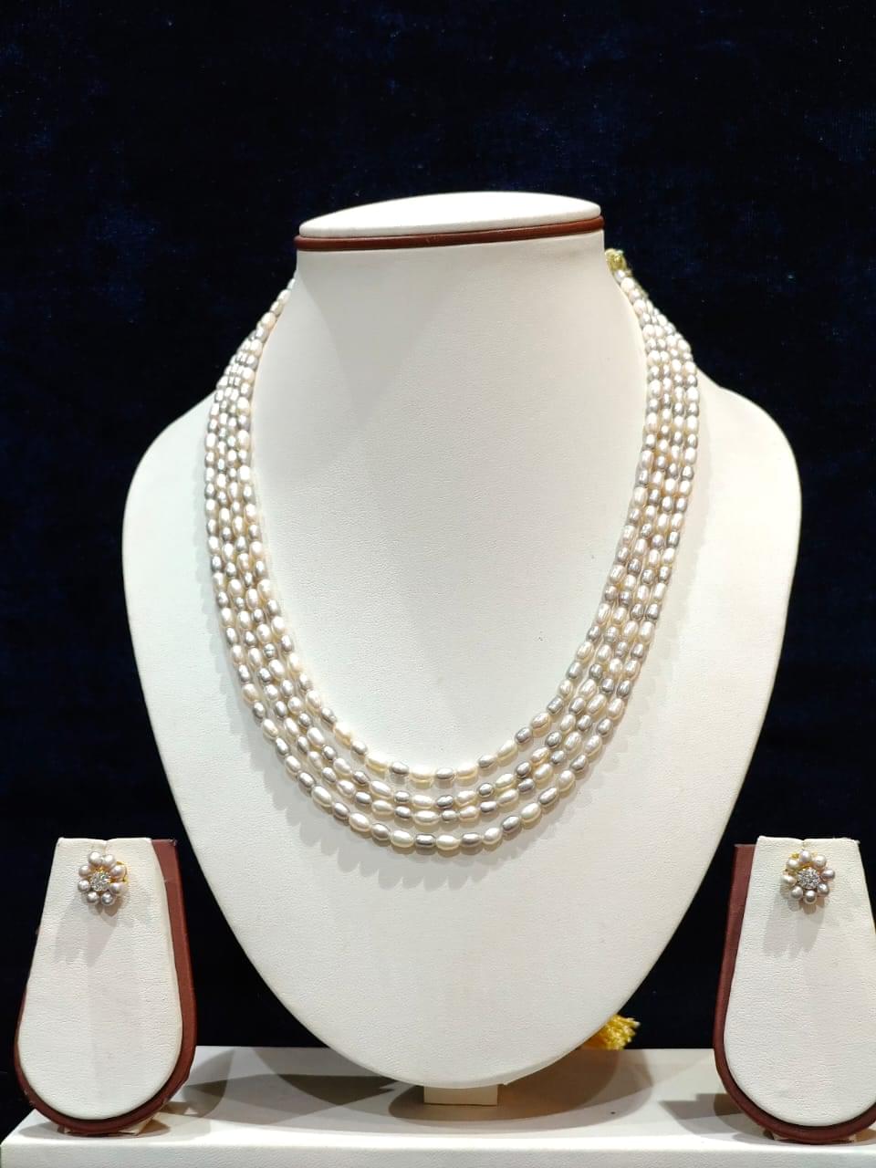 Elegant three-line rice pearl set featuring a combination of gray and white pearls, creating a sophisticated and chic design for any occasion.