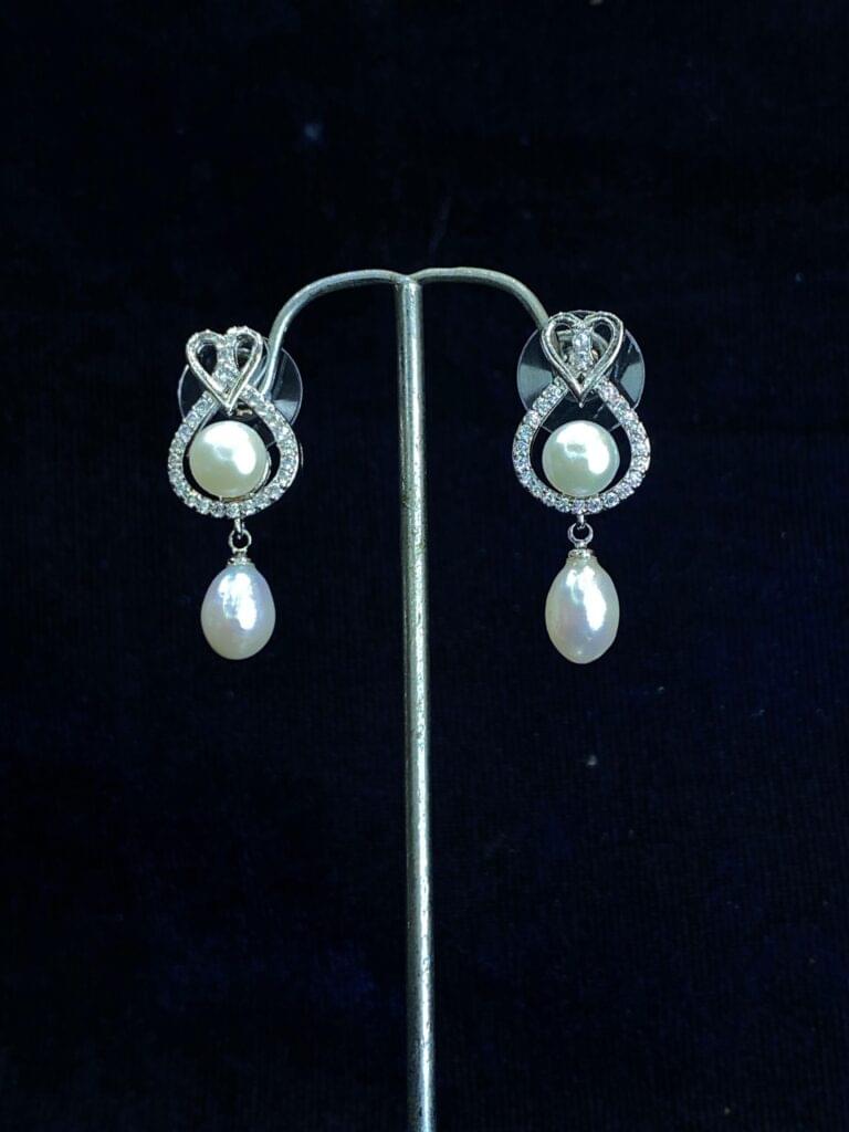 Heart and Soul Pearl Studs featuring a romantic heart-shaped design with pearls.