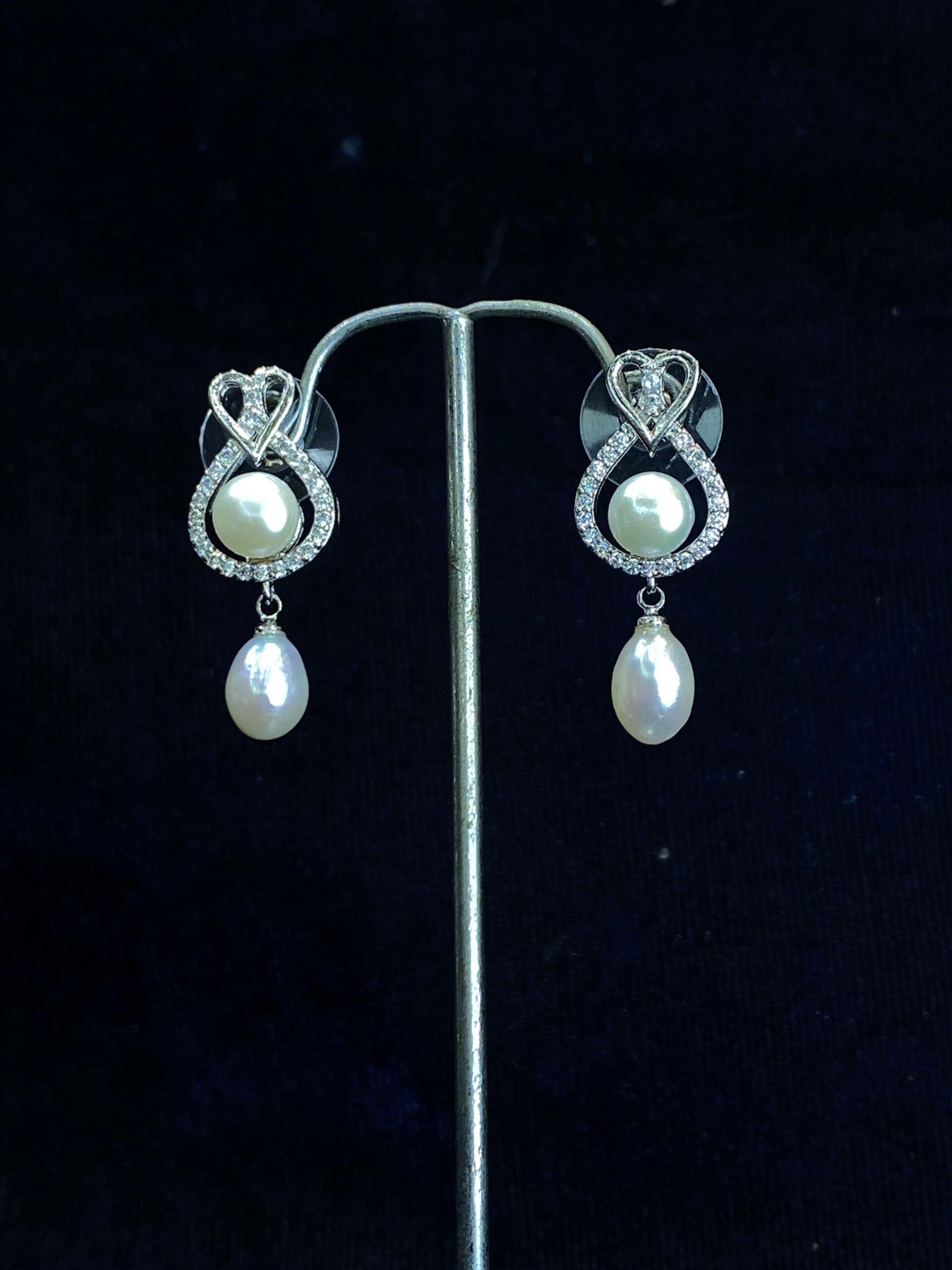 Heart and Soul Pearl Studs featuring a romantic heart-shaped design with pearls.