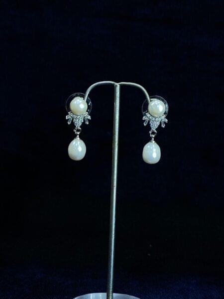 Pearl Teardrop Studs with a graceful teardrop design for refined elegance.