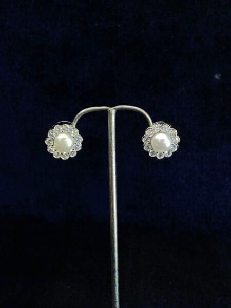 Floral Halo Pearl Studs with delicate floral detailing.