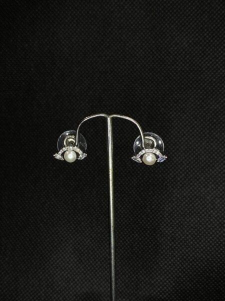 Pearl Wing Studs featuring a delicate wing design with a central pearl.