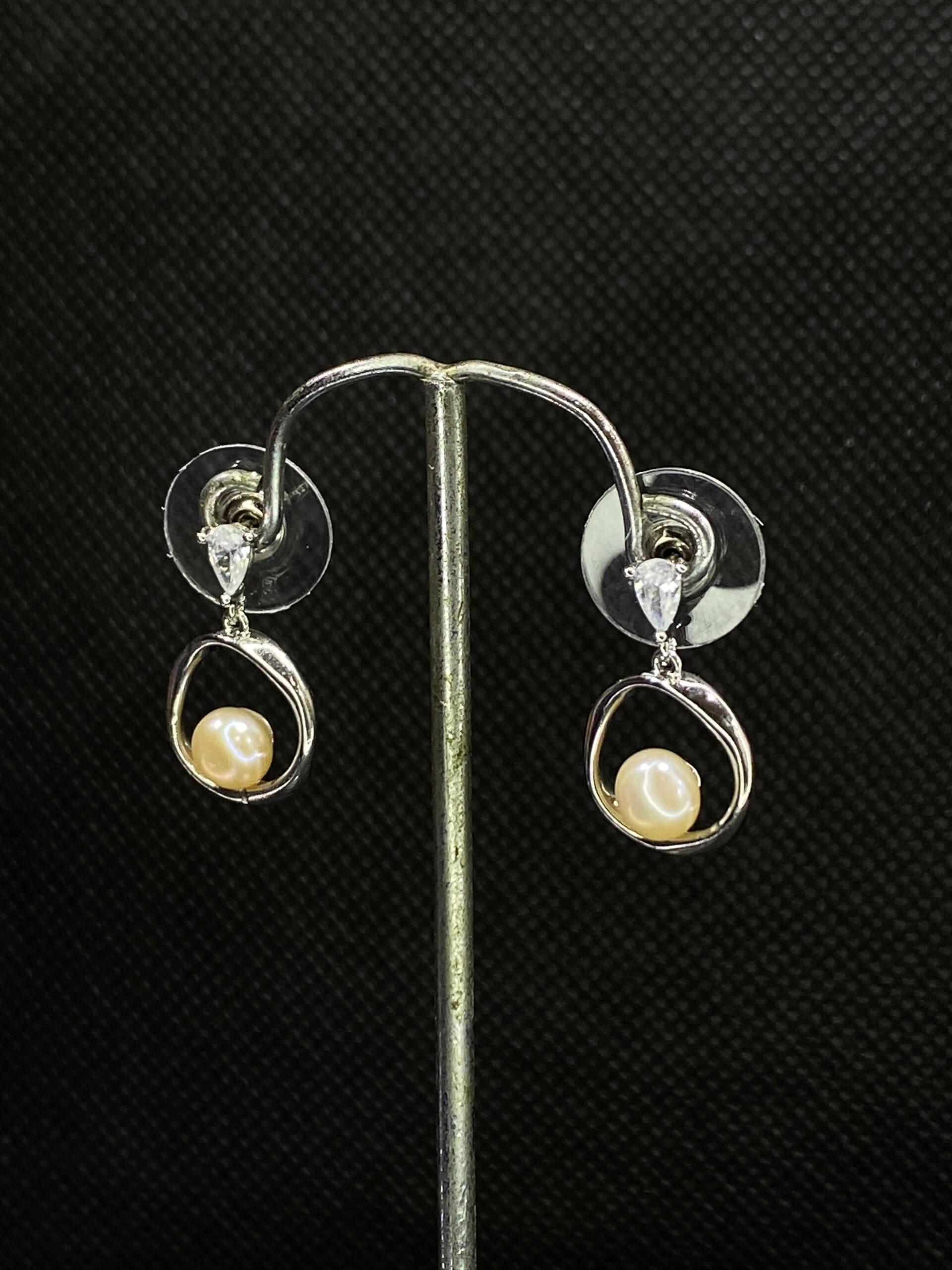 Pearl Halo Studs featuring a radiant halo design for timeless sophistication.