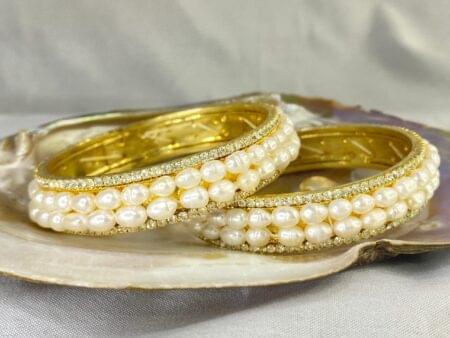 Double Line Pearl Bangle featuring two rows of lustrous pearls set in an elegant and sophisticated design.