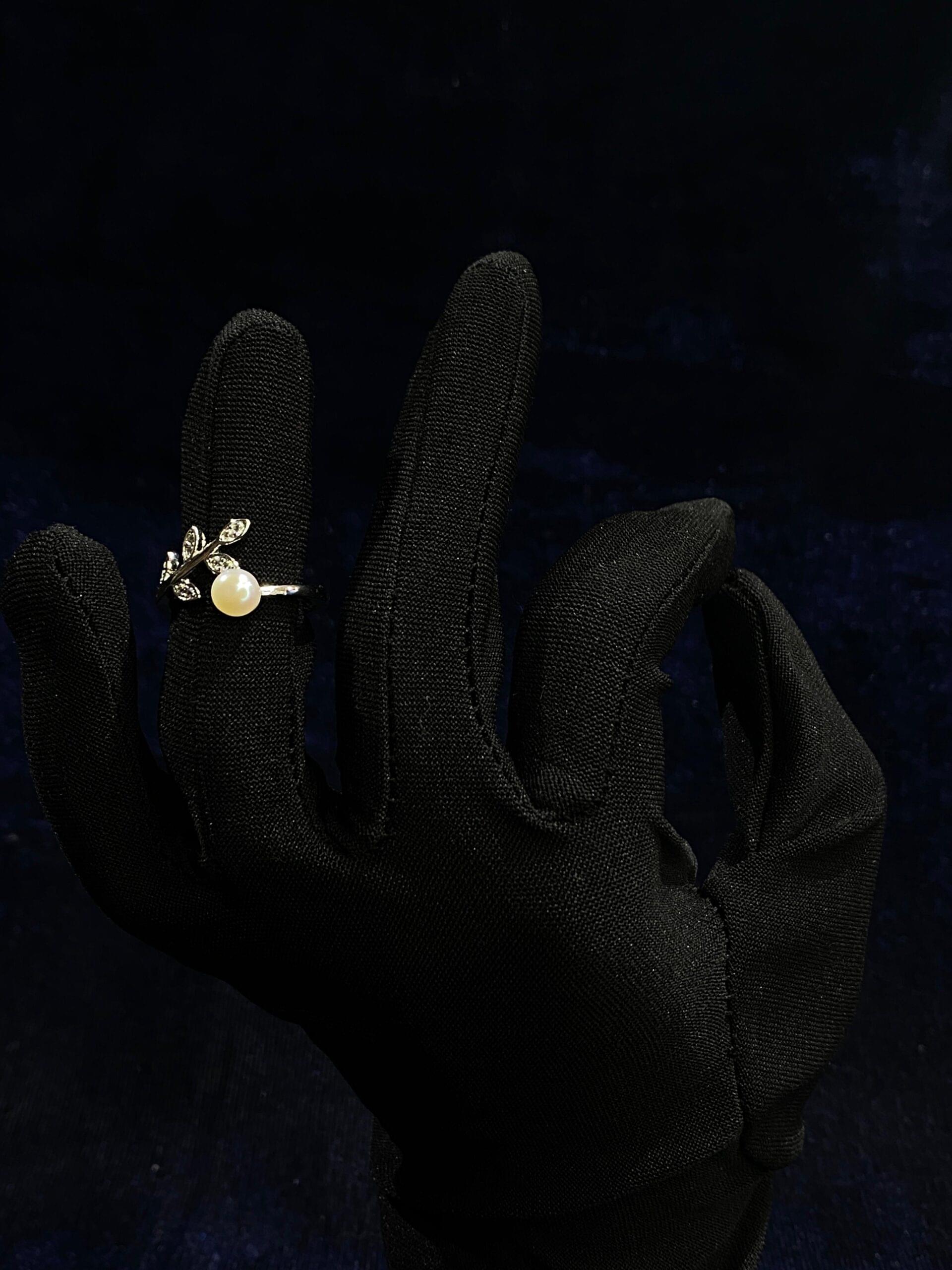 Delicate Leaf Pearl Ring with intricate leaf patterns and a luminous pearl centerpiece.