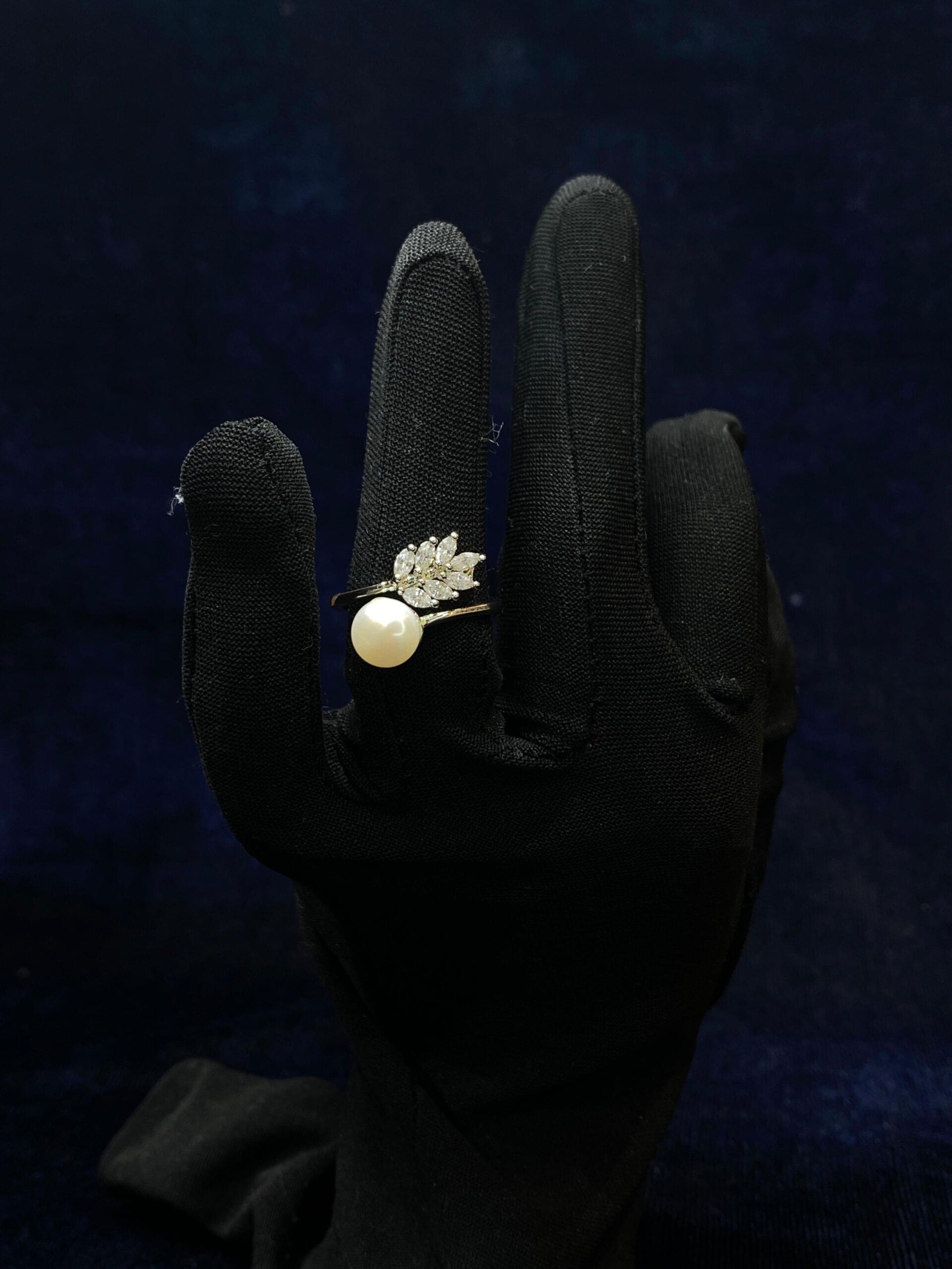 Leafy Pearl Ring featuring a delicate pearl surrounded by leaf-inspired accents.