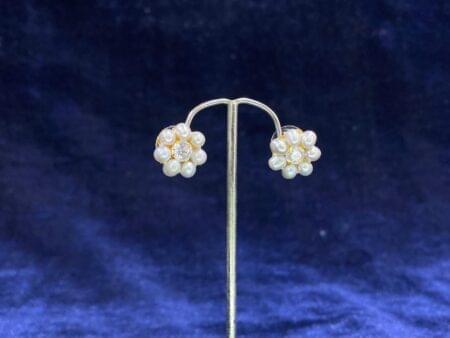 Pearl Daisy Stud Tops with a charming daisy-inspired floral design and pearl center.