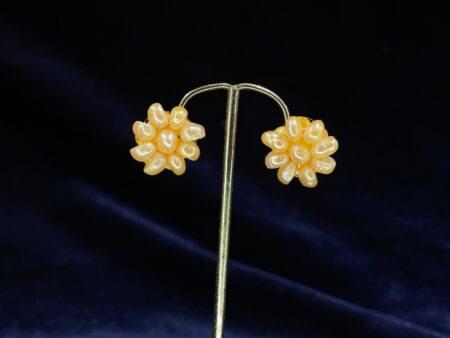 Pearl Blossom Stud Tops with a floral design featuring a central pearl.