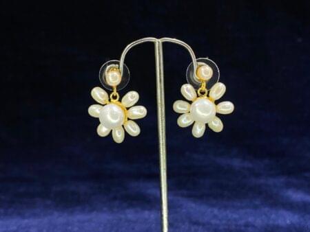 Pearl Blossom Drop Earrings featuring a radiant floral-inspired design for timeless beauty.