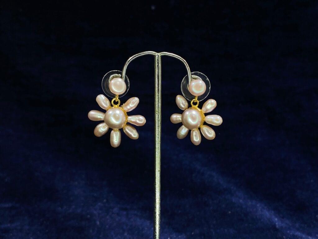 Pearl Blossom Drop Earrings featuring a radiant floral-inspired design for timeless beauty.