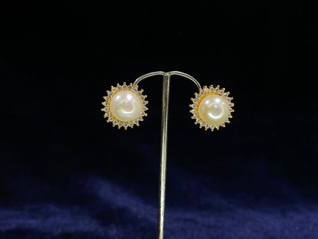 Pearl Halo Stud Tops with a classic pearl encircled by a radiant halo design.