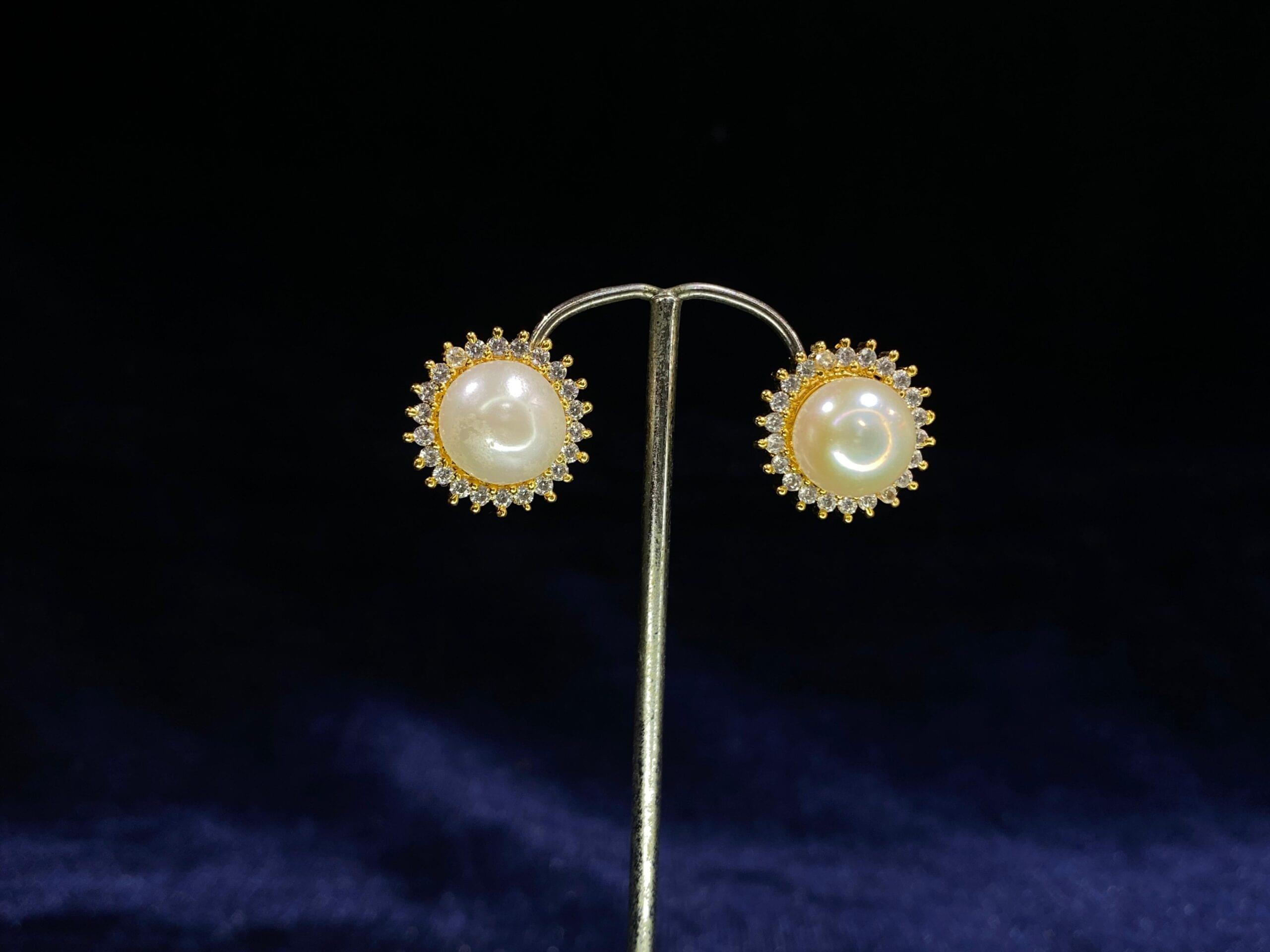 Pearl Halo Stud Tops with a classic pearl encircled by a radiant halo design.