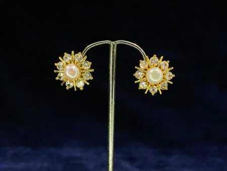 Pearl Sunburst Tops featuring a radiant sunburst design with a central pearl.