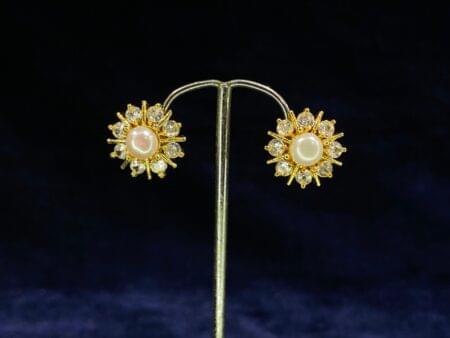 Pearl Sunburst Tops featuring a radiant sunburst design with a central pearl.
