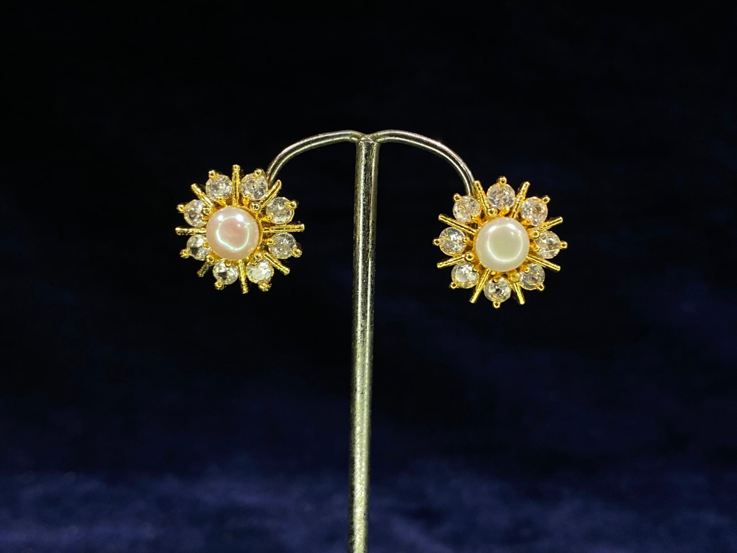 Pearl Sunburst Tops featuring a radiant sunburst design with a central pearl.