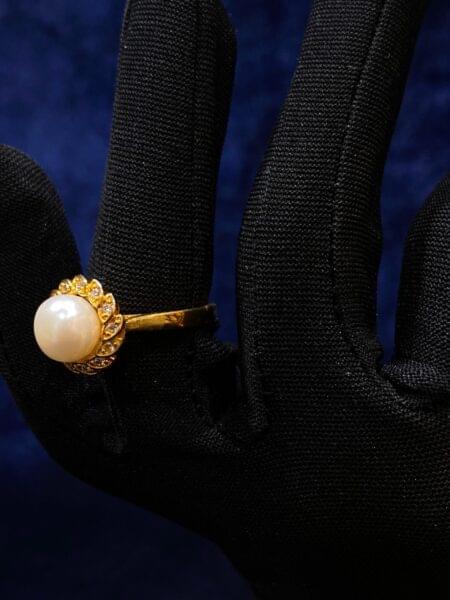 Pearl Blossom Ring featuring a delicate floral design with a luminous pearl center.